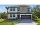 A charming two-story home boasts meticulous landscaping, a two-car garage and lush, mature landscaping at 4441 Ganesha Loop, Kissimmee, FL 34746