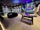 Spacious game room featuring a seating area, foosball table, air hockey and space themed decor at 4441 Ganesha Loop, Kissimmee, FL 34746