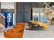 A modern kitchen featuring dark cabinetry, stainless steel appliances, and stylish counter seating at 4441 Ganesha Loop, Kissimmee, FL 34746