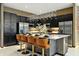 Modern kitchen with a large island, seating, stainless steel appliances, and elegant lighting at 4441 Ganesha Loop, Kissimmee, FL 34746