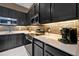 Modern kitchen with black cabinets, stainless steel appliances, and stylish backsplash at 4441 Ganesha Loop, Kissimmee, FL 34746