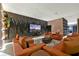 Stunning living room featuring lighted accent wall, stylish orange sofas, and marble floors at 4441 Ganesha Loop, Kissimmee, FL 34746