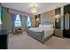 Elegant bedroom showcasing a luxurious bed, decorative lighting, and stylish wallpaper with natural light at 4441 Ganesha Loop, Kissimmee, FL 34746