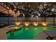 A private in-ground pool and attached hot tub feature clean tiling, a screened enclosure and lounge furniture at 4441 Ganesha Loop, Kissimmee, FL 34746