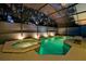 The private in-ground pool and attached hot tub are enclosed with a screened enclosure and landscape views at 4441 Ganesha Loop, Kissimmee, FL 34746