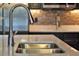 Close-up of a stainless steel sink with stylish faucet and backsplash in a modern kitchen at 4441 Ganesha Loop, Kissimmee, FL 34746