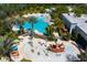 Aerial view of community pool, splash pad, and lounging areas with mature landscaping at 454 Captiva Dr, Davenport, FL 33896