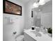 Modern bathroom with white vanity, mirror and shower at 454 Captiva Dr, Davenport, FL 33896