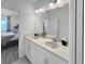 Well-lit bathroom featuring double sinks and a view into the bedroom at 454 Captiva Dr, Davenport, FL 33896