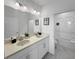 Bright bathroom with a double vanity, modern fixtures, and a walk-in shower at 454 Captiva Dr, Davenport, FL 33896