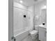 Bright bathroom featuring a shower and tub with clean, marble-look tile and a white vanity at 454 Captiva Dr, Davenport, FL 33896