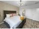 Cozy bedroom featuring stylish wallpaper, a comfy bed, and a chandelier at 454 Captiva Dr, Davenport, FL 33896