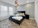 Comfortable bedroom with a stylish accent wall, modern lighting, and a cozy bed at 454 Captiva Dr, Davenport, FL 33896