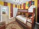 bedroom with bunkbeds, rug, wood floor, and cute decoration at 454 Captiva Dr, Davenport, FL 33896
