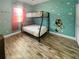 Fun bedroom featuring a bunk bed, playful decor, and a bright window, creating a cozy and inviting space at 454 Captiva Dr, Davenport, FL 33896