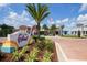A view of the Downtown Festival community entrance sign, palm trees, and storefronts at 454 Captiva Dr, Davenport, FL 33896