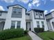 Stylish two-story townhome with modern gray trim, lush landscaping, and a welcoming front entrance at 454 Captiva Dr, Davenport, FL 33896
