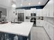 Bright kitchen with white cabinets, stainless steel appliances, and quartz countertops at 454 Captiva Dr, Davenport, FL 33896