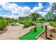 Scenic miniature golf course with lush greenery and mature palm trees at 454 Captiva Dr, Davenport, FL 33896
