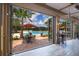 This outdoor patio has folding glass doors looking at a community pool with tables and chairs for relaxing at 454 Captiva Dr, Davenport, FL 33896
