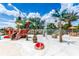 A whimsical splash pad features a pirate theme with water cannons and playful fountains, surrounded by tropical landscaping at 454 Captiva Dr, Davenport, FL 33896