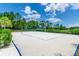 Outdoor sand volleyball court surrounded by lush landscaping and blue skies at 454 Captiva Dr, Davenport, FL 33896
