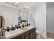 Bathroom featuring double sinks, vanity, granite countertop, and tile flooring at 503 Meadow Pointe Dr, Haines City, FL 33844