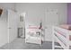 This well-lit Bedroom features a changing table, a baby gate, and a bunk bed at 503 Meadow Pointe Dr, Haines City, FL 33844
