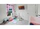 Bright Bedroom with colorful play area, pink curtains, and a wall-mounted TV at 503 Meadow Pointe Dr, Haines City, FL 33844