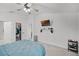 Bright bedroom featuring a ceiling fan and a TV mounted on the wall at 503 Meadow Pointe Dr, Haines City, FL 33844