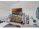Bedroom features a large dresser and a wall-mounted TV at 503 Meadow Pointe Dr, Haines City, FL 33844