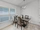 Bright dining room with a modern chandelier and large window at 503 Meadow Pointe Dr, Haines City, FL 33844