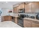 Well-equipped kitchen with stone backsplash, sleek appliances, and ample cabinet space at 503 Meadow Pointe Dr, Haines City, FL 33844