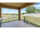 Covered back patio with views of the backyard and a partial view of the neighborhood at 5515 Windsong Oak Dr, Leesburg, FL 34748