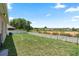 Fenced backyard with lush green grass, offering ample space for recreation and outdoor activities at 5515 Windsong Oak Dr, Leesburg, FL 34748