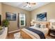 Well-lit bedroom featuring stylish decor, a large window, and a cozy rug at 5515 Windsong Oak Dr, Leesburg, FL 34748