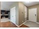 Hallway featuring a kitchen, tile floors, and a door to the front entrance of the home at 5515 Windsong Oak Dr, Leesburg, FL 34748