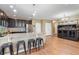 Stylish kitchen with a breakfast bar and an adjacent living area featuring a large fish tank at 5515 Windsong Oak Dr, Leesburg, FL 34748