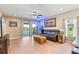 Cozy living area with hardwood floors, ample natural light, and sliding door access to the backyard at 5515 Windsong Oak Dr, Leesburg, FL 34748
