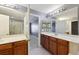 Well-lit primary bathroom featuring double sinks, vanity cabinets, and a walk-in glass door shower at 585 Cruz Bay Cir, Winter Springs, FL 32708