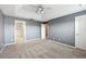 Spacious bedroom with neutral carpet, trey ceiling, and doors to the bathroom and hallway at 585 Cruz Bay Cir, Winter Springs, FL 32708
