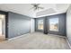 Bedroom with trey ceiling, ceiling fan, and large windows providing natural light and a cozy atmosphere at 585 Cruz Bay Cir, Winter Springs, FL 32708