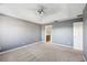 Spacious bedroom with neutral carpet, a trey ceiling, a ceiling fan, and a door leading to the bathroom at 585 Cruz Bay Cir, Winter Springs, FL 32708