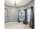Bright dining room features neutral colors, tile floors, modern chandelier, and natural light from the nearby windows at 585 Cruz Bay Cir, Winter Springs, FL 32708