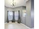 Dining room with neutral gray walls, two large windows and ceramic tile floors at 585 Cruz Bay Cir, Winter Springs, FL 32708