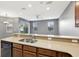 A view of the kitchen island with a sink and seating area at 585 Cruz Bay Cir, Winter Springs, FL 32708