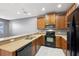 Kitchen with wood cabinets, stainless steel appliances, and gray walls at 585 Cruz Bay Cir, Winter Springs, FL 32708