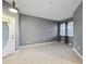 Inviting living room with tiled floors, a front door and large window at 585 Cruz Bay Cir, Winter Springs, FL 32708