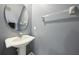 Cozy powder room with pedestal sink, round mirror, and neutral colors offering a comfortable and convenient space at 585 Cruz Bay Cir, Winter Springs, FL 32708