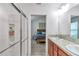 Bathroom featuring a walk-in shower, double vanity, and access to main bedroom at 6223 Atkinson Ln, The Villages, FL 32163